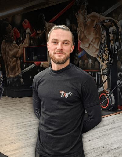 Jocelyn, coach sportif, devant la fresque de la salle